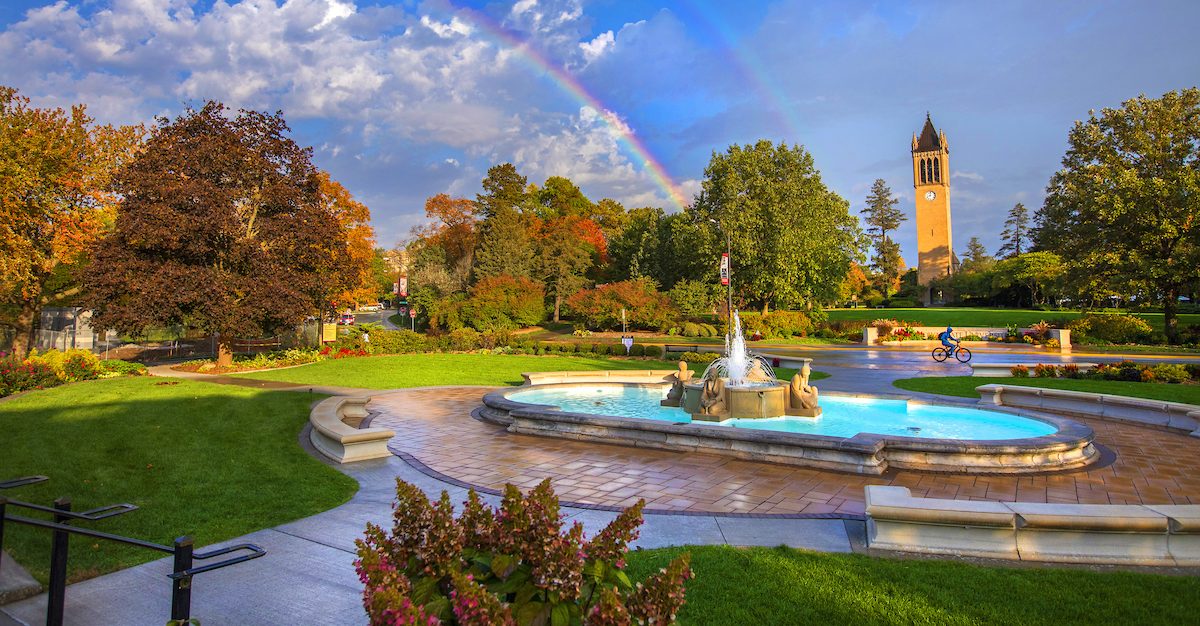 Shot of the fountain at Iowa State University with a double rainbow and the campanile